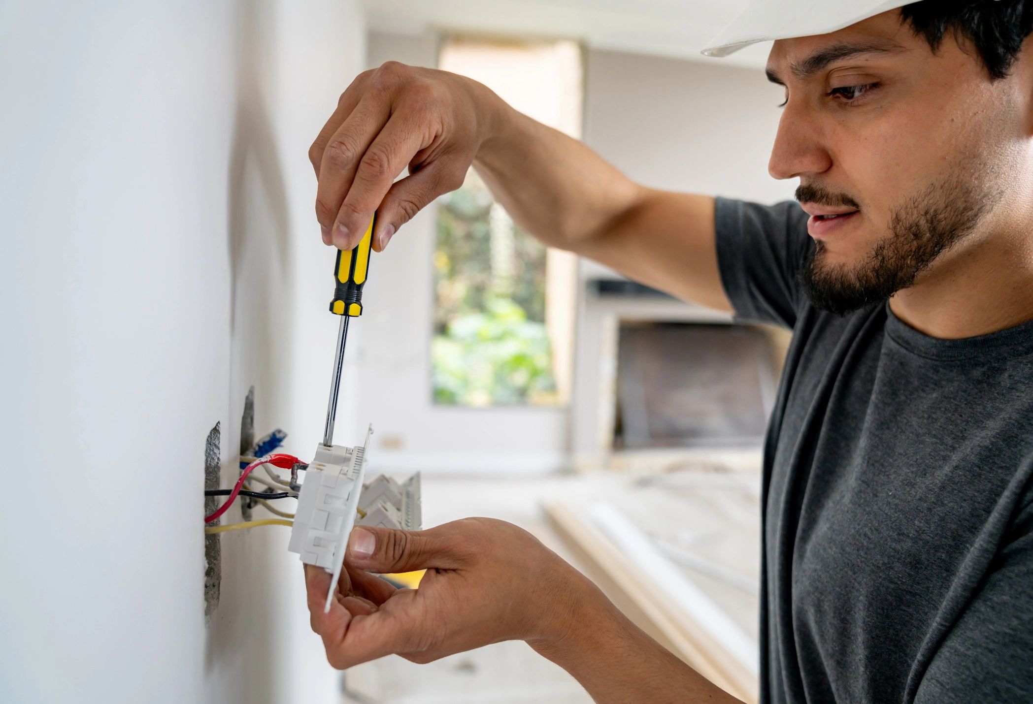 Electrician installing a power socket during a home electrical upgrade