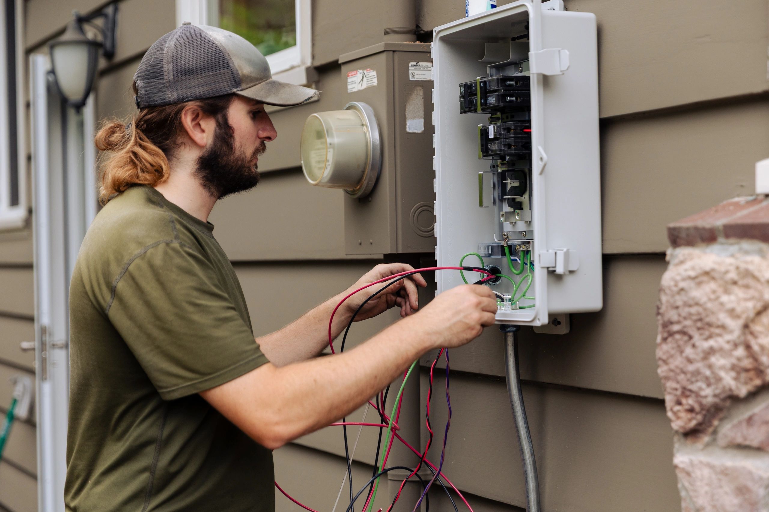 Electrician working on a consumer unit for a safe, compliant installation